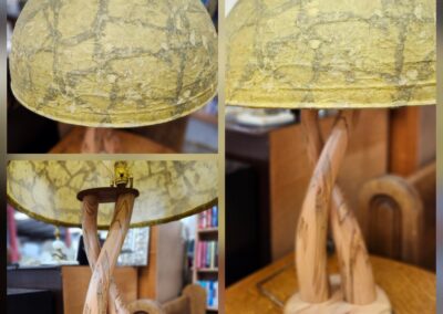 Wooden sculpture with a detailed globe and abstract base design.