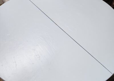 Round white table with a visible seam in the middle.
