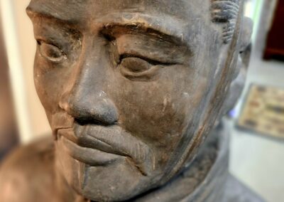 Close-up of a weathered stone statue's face.