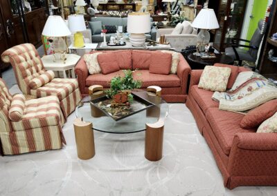 Cozy living room with coral sofas and a glass coffee table.