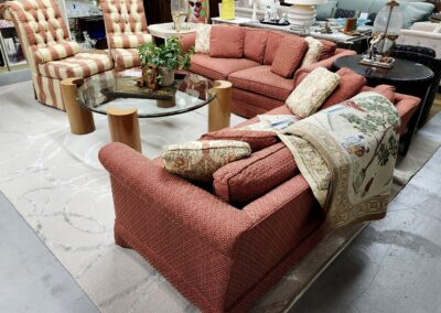 Cozy red sectional sofa with patterned throw blanket in a stylish living room.