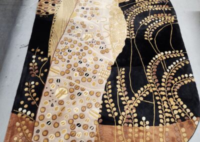 Elegant fabric with gold, black, and beige patterns.