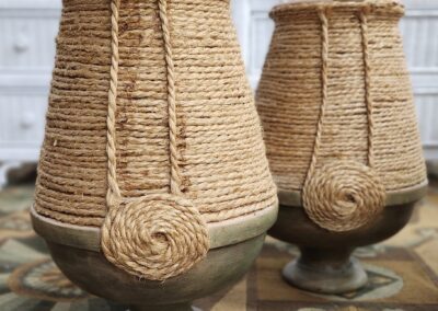 Two handcrafted jute thread vases with unique spiral designs.