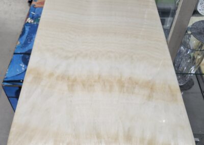 Polished beige marble slab with natural pattern on display.