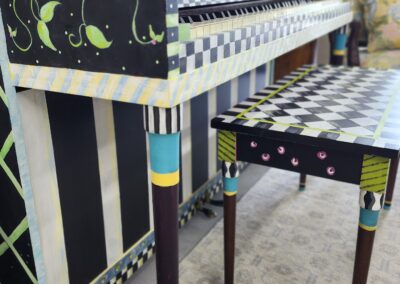 Colorful, patterned wooden table and bench set with artistic designs.