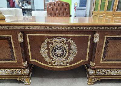 Ornate wooden furniture with intricate carvings and gold accents.