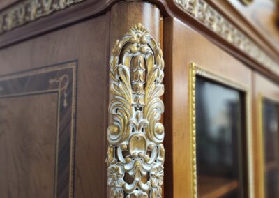 Ornate wooden furniture with intricate gold detailing.