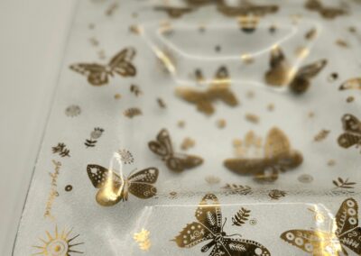 Clear sheet with gold butterfly stickers of various sizes and designs.
