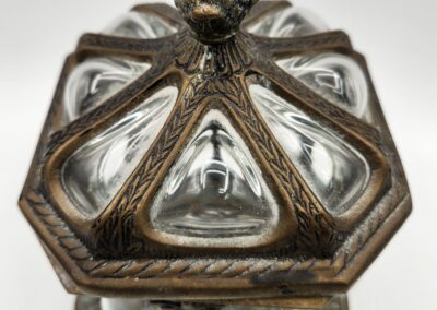 Close-up of an ornate metallic lantern with glass panels.