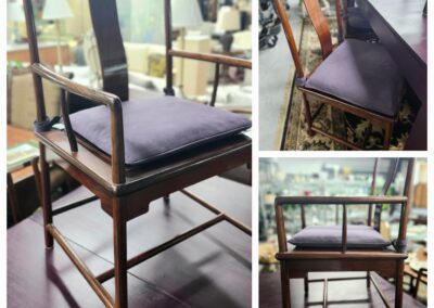 Wooden chair with cushioned seat and backrest in a rustic setting.