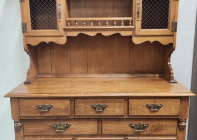 Vintage wooden hutch with drawers and cabinet doors.