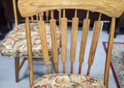 Wooden dining chair with floral cushioned seat and backrest.