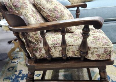 Wooden rocking chair with floral cushions in a cozy living room.