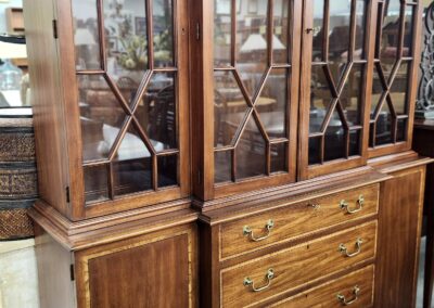 Vintage wooden cabinet with glass doors and drawers.