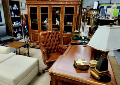 Elegant wooden office desk and leather chair in a classic study room.