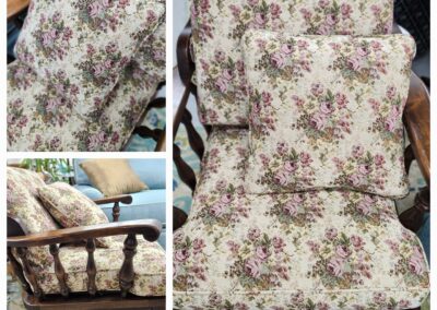 Floral patterned cushions arranged on a wooden chair.