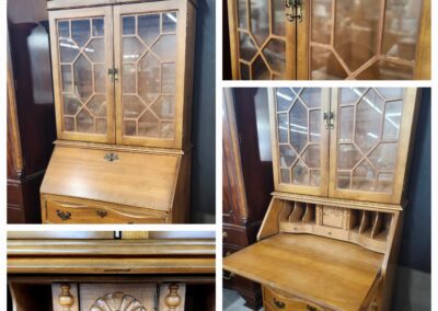 Antique wooden secretary desk with glass display cabinet and intricate detailing.