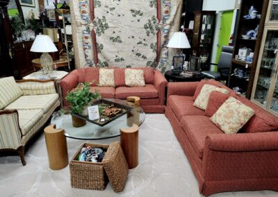 Cozy living room with floral and patterned sofas and warm lighting.