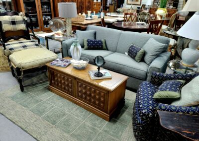 Cozy living room setup with a gray sofa and a wooden coffee table.