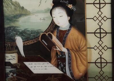 A traditional Japanese woman reading a book indoors.