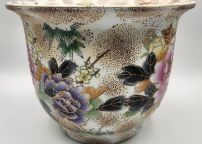 Decorative floral ceramic pot with intricate gold accents.