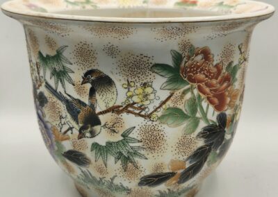 Decorative porcelain bowl with birds and floral designs.
