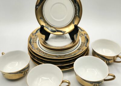 Elegant vintage tea set with gold accents and intricate designs.