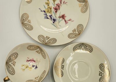 Set of three ceramic dishes with floral and butterfly designs.