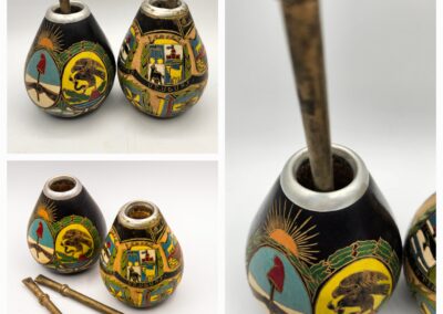Colorful painted yerba mate gourds and bombillas on a white background.