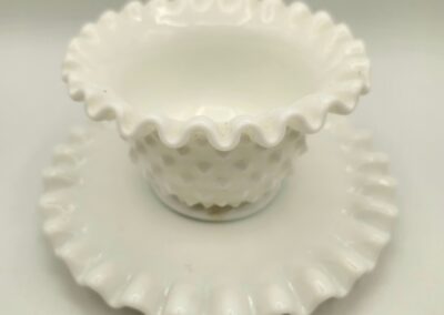 White ruffled-edge glass dish with matching plate.