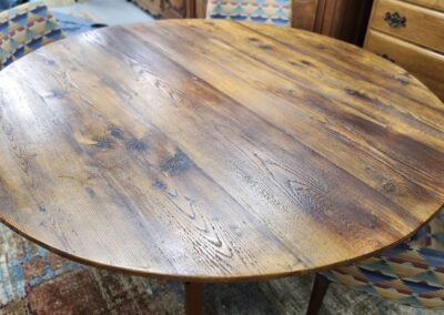 Rustic wooden round table with natural grain patterns.