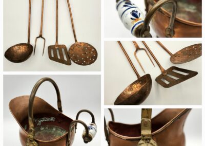 Antique copper kitchen utensils and a kettle with ornate handles.
