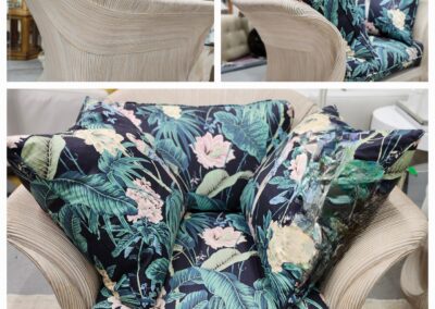 Close-up of a chair with floral-patterned cushions and beige upholstery.