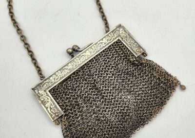 Vintage mesh purse with ornate metal frame and chain handle.