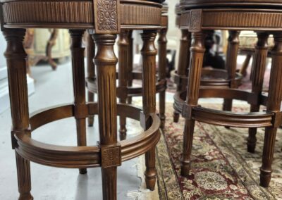 Close-up of two wooden bar stools with intricate detailing.