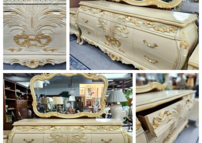 Elegant vintage dresser with ornate floral designs and a matching mirror.