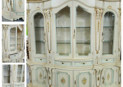 Ornate vintage cream-colored cabinet with glass doors and intricate gold detailing.