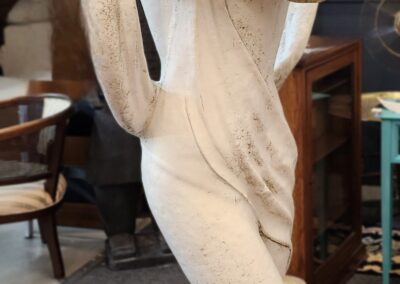 A close-up of a classical marble statue in a gallery.