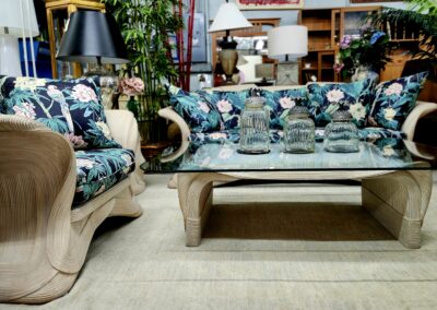 Elegant living room with floral sofas and a glass coffee table.