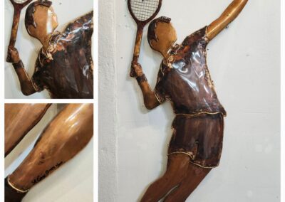 Wall sculpture of a basketball player dunking a ball.