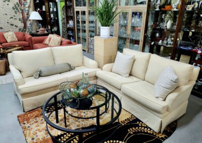 Cozy beige sofas arranged around a black glass coffee table in a stylish living room.