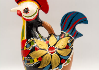 Colorful ceramic rooster sculpture with intricate floral patterns.