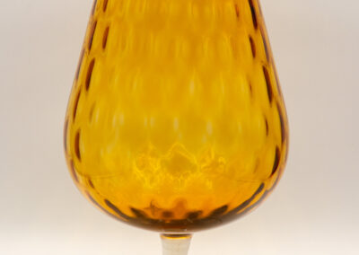 Amber glass goblet with textured diamond pattern.