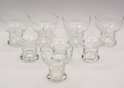 Set of clear glass dessert cups with short stems.
