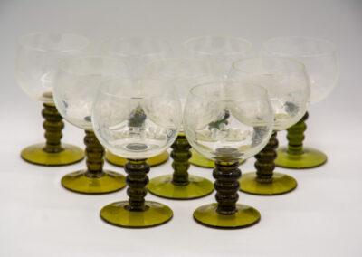 Vintage green-stemmed glassware arranged in neat rows.