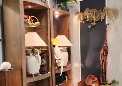 A cozy corner with wooden shelves, lamps, and decorative items.