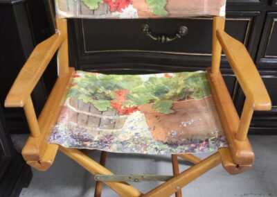 Wooden director's chair with floral fabric seat and backrest.