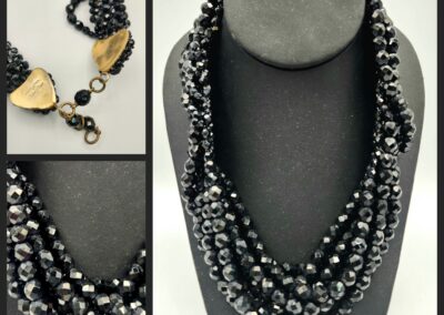 Elegant multi-strand black and silver beaded necklace on display.