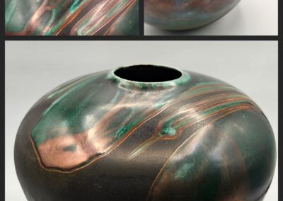 A glossy, rounded ceramic vase with swirling metallic colors.