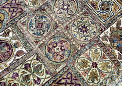 Close-up of a multicolored tapestry with intricate patterns and designs.